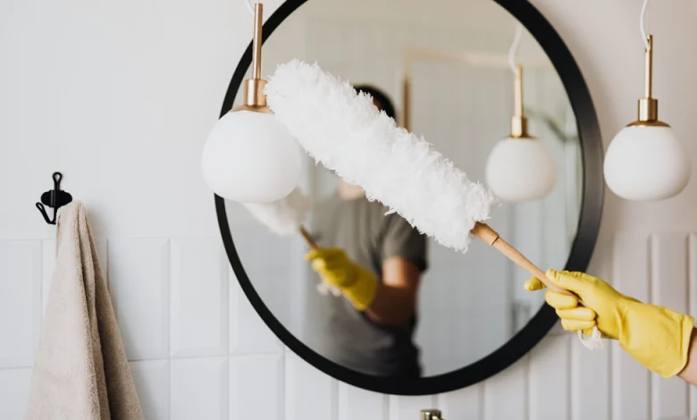 a person holding a white feather duster